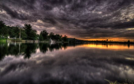 HDR image of a serene lake at sunset with dramatic clouds overhead, reflecting on the still water. This HD nature wallpaper is tagged for desktop background use.
