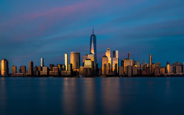 4K Ultra HD image of Manhattan’s skyline at sunset, showcasing iconic New York architecture along the waterfront in the USA.