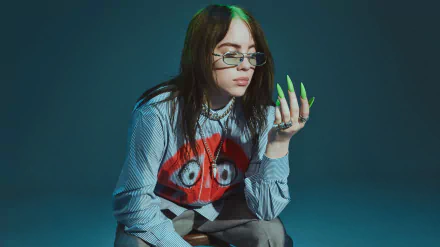 Portrait of American singer Billie Eilish with long neon green nails and layered jewelry, set against a dark background in 4K Ultra HD quality.