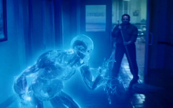 A dramatic scene from the movie *Watchmen*, featuring Doctor Manhattan, a luminous blue figure, against a dark background with a standing man in the foreground. HD wallpaper.
