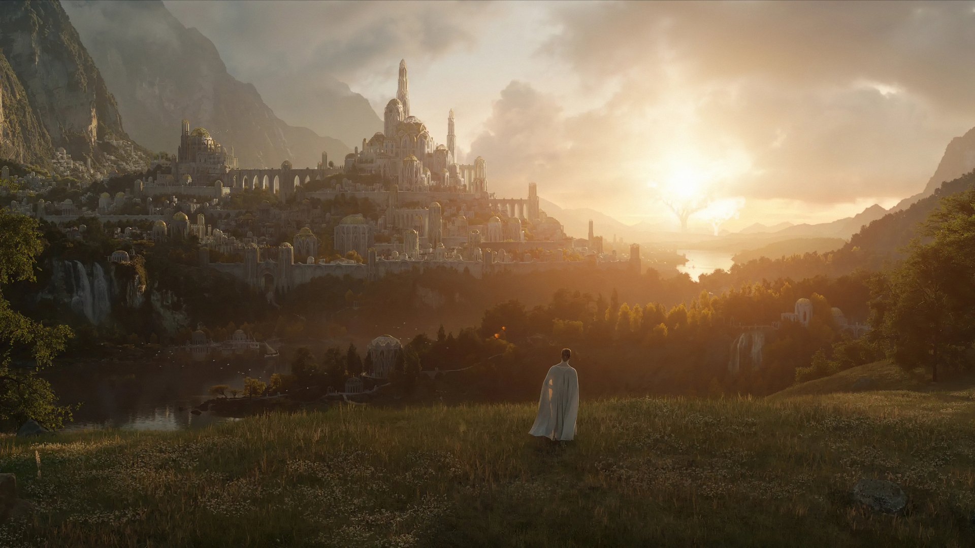HD PC desktop wallpaper from the TV show The Lord of the Rings: The Rings of Power — a cloaked figure overlooks a sunlit, sprawling city by mountains and the sea.