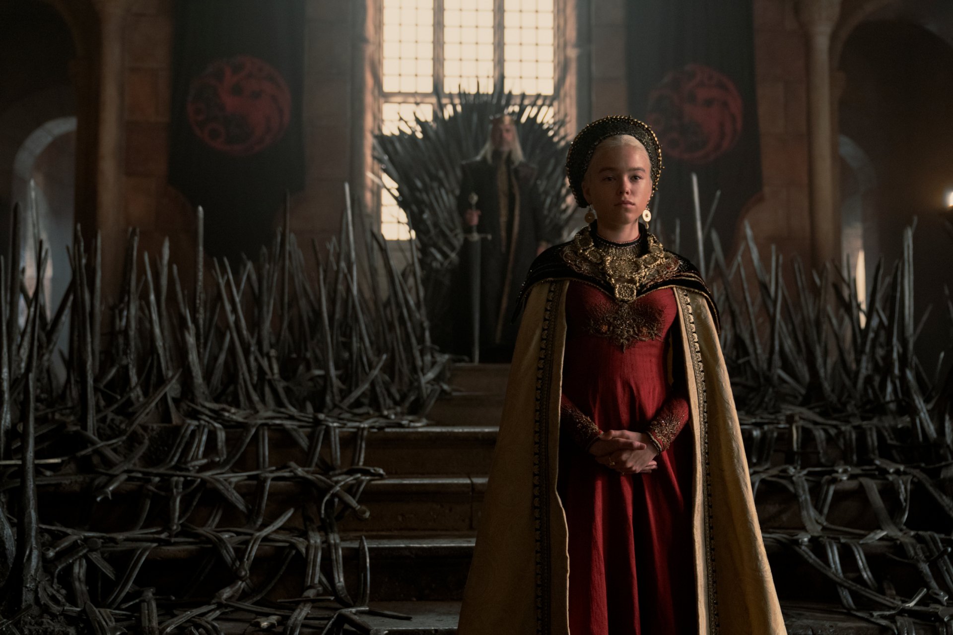 HD desktop wallpaper featuring Milly Alcock as Rhaenyra Targaryen from the TV show House of the Dragon, standing in the throne room before the Iron Throne.