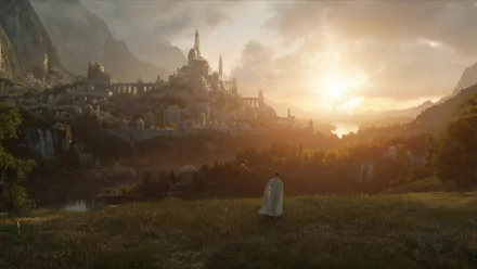 HD PC desktop wallpaper from the TV show The Lord of the Rings: The Rings of Power — a cloaked figure overlooks a sunlit, sprawling city by mountains and the sea.