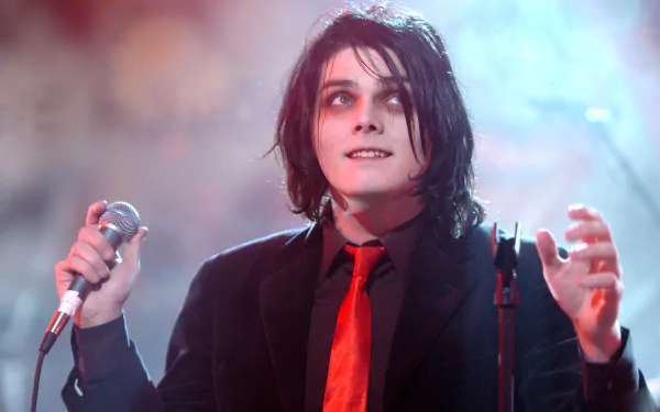 My Chemical Romance–inspired music 2K Quad HD desktop wallpaper: gothic vocalist in a black suit and red tie holding a microphone on a smoky, theatrical stage.