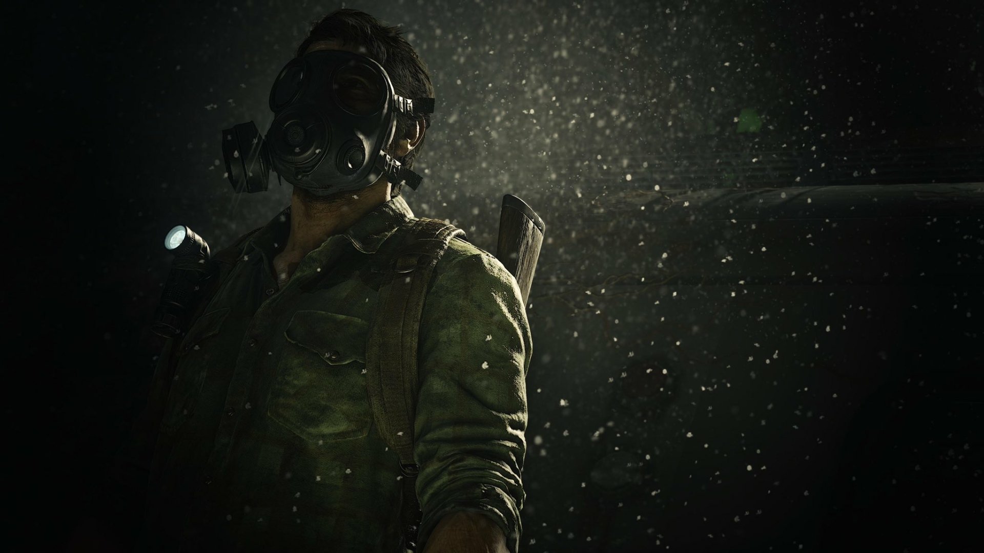 HD PC desktop wallpaper featuring Joel (The Last of Us) from the video game The Last of Us Part I: a rugged survivor in a gas mask with flashlight, rain and dust illuminated against a dark backdrop.