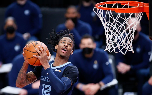 Ja Morant, Memphis Grizzlies point guard, showcased in this vibrant and high-quality desktop wallpaper. A dynamic and captivating sports-themed background.