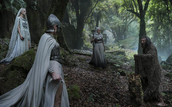 HD desktop wallpaper from The Lord of the Rings: The Rings of Power TV show, showing four characters in medieval attire in a misty, forested setting.