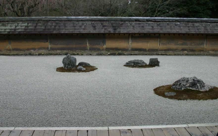HD desktop wallpaper featuring a serene Japanese garden with carefully arranged rocks on a raked gravel surface, showcasing minimalist natural beauty.