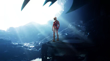 4K Ultra HD PC desktop wallpaper: The Flash (2023) in a scarlet suit stands on a rocky platform inside a glowing cavern, a giant bat-shaped silhouette looming overhead.