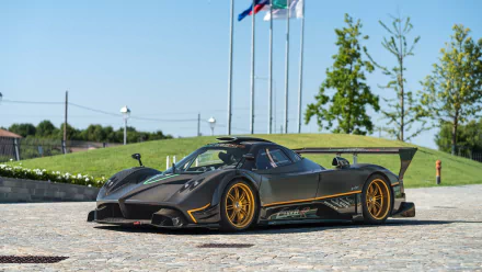 A sleek Pagani Zonda R sports car showcased on a sunny day, featured in a 4K Ultra HD PC desktop wallpaper and background.