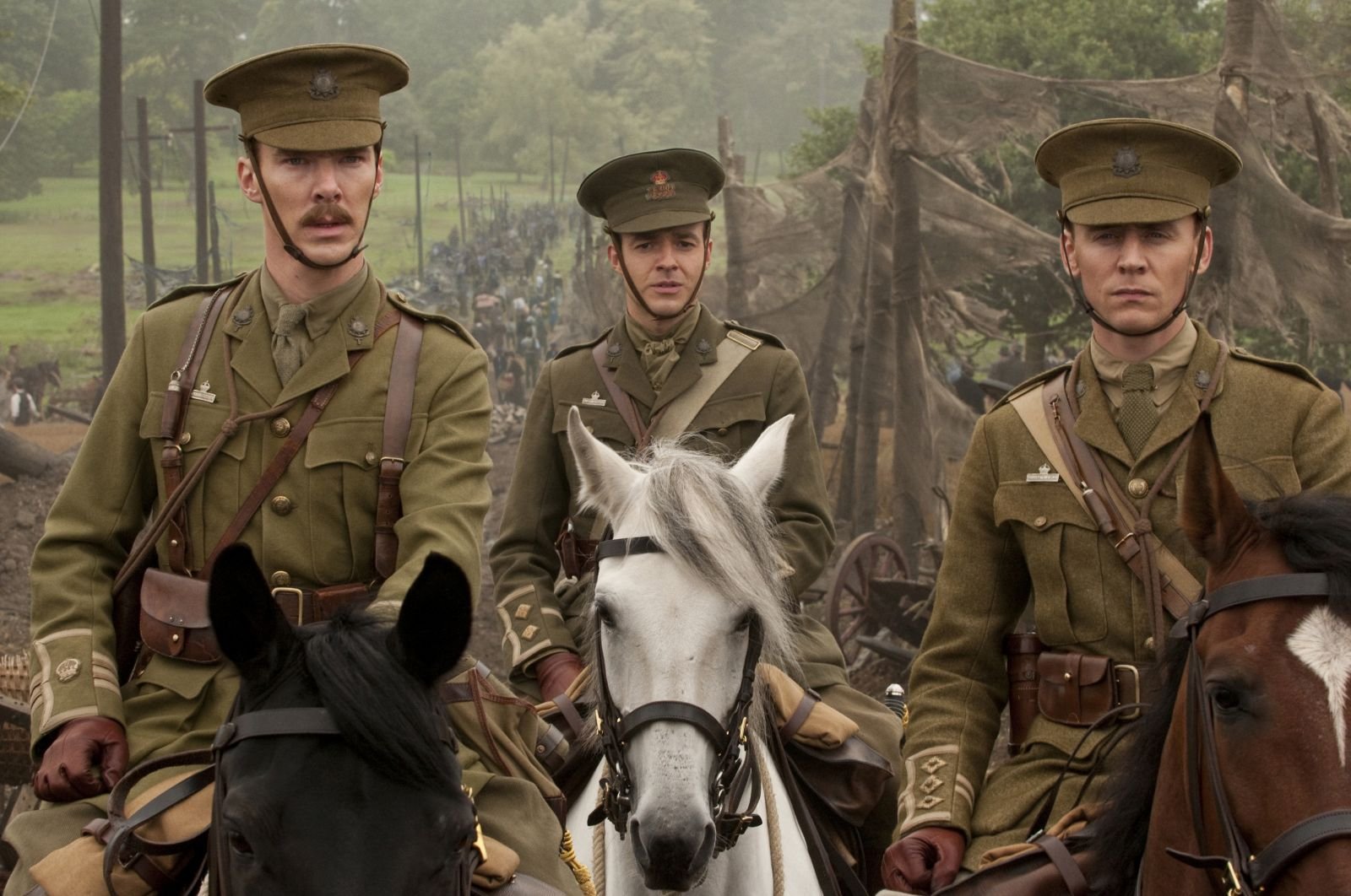 HD PC desktop wallpaper featuring three soldiers on horseback from the movie War Horse, set in a misty, wooded battlefield environment.