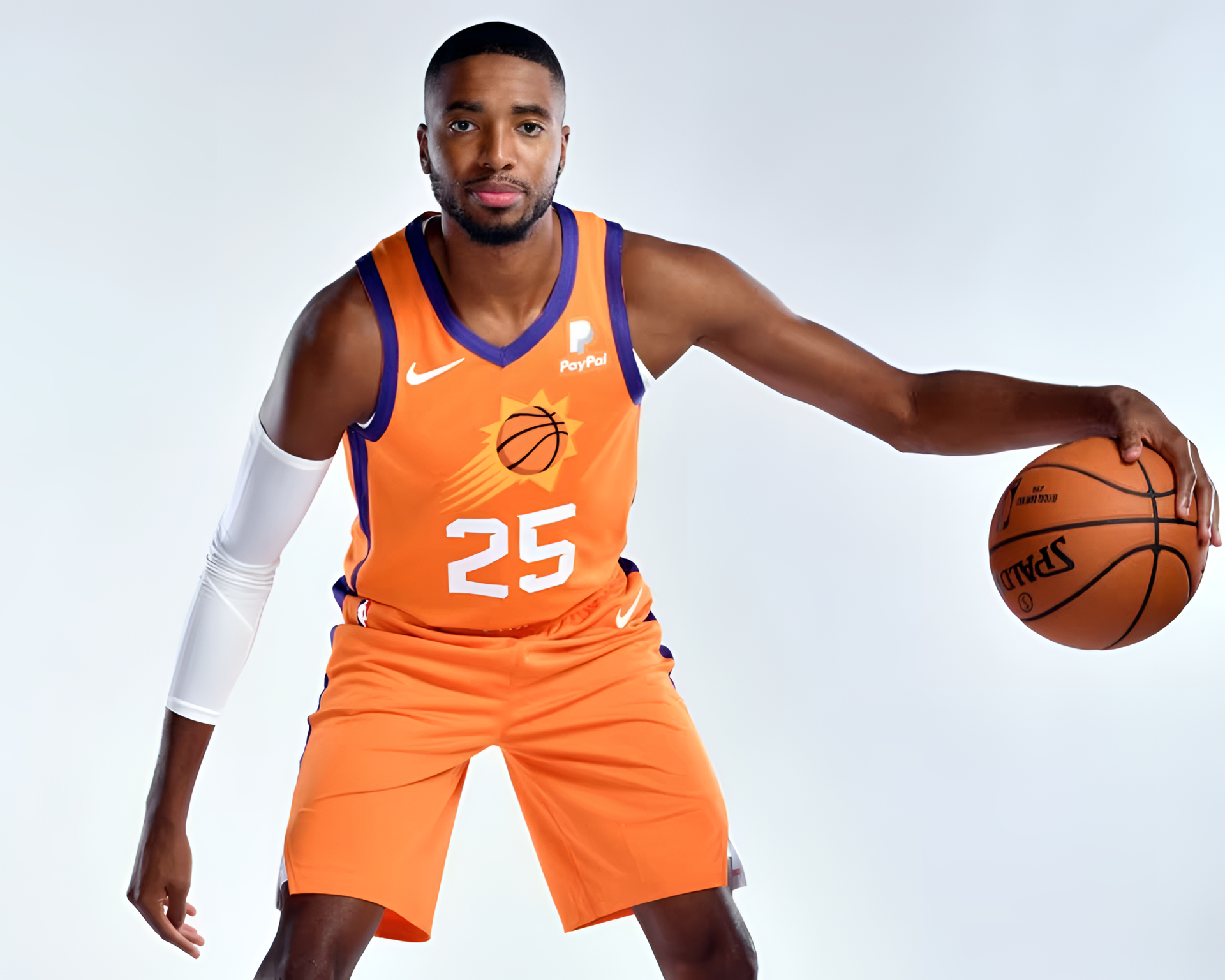 HD wallpaper featuring Mikal Bridges in an orange Phoenix Suns basketball uniform, holding a basketball, against a white background.