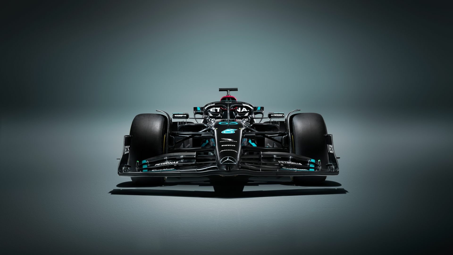 HD desktop wallpaper featuring a front view of the Mercedes W14 Formula 1 car, centered against a smooth gradient gray background.