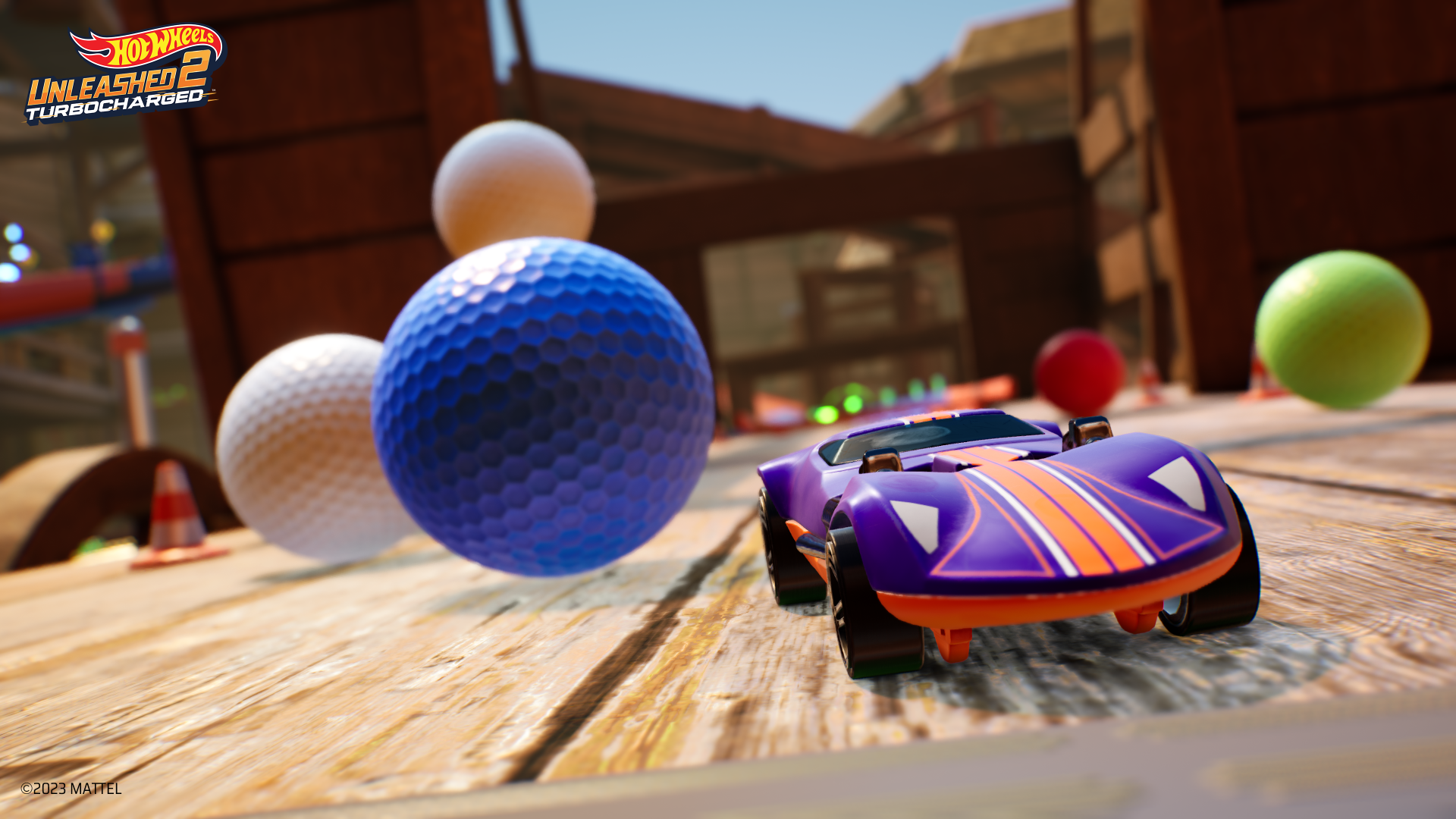 HD desktop wallpaper from Hot Wheels Unleashed 2: Turbocharged featuring a vibrant toy car racing amid oversized colorful balls on a wooden track.