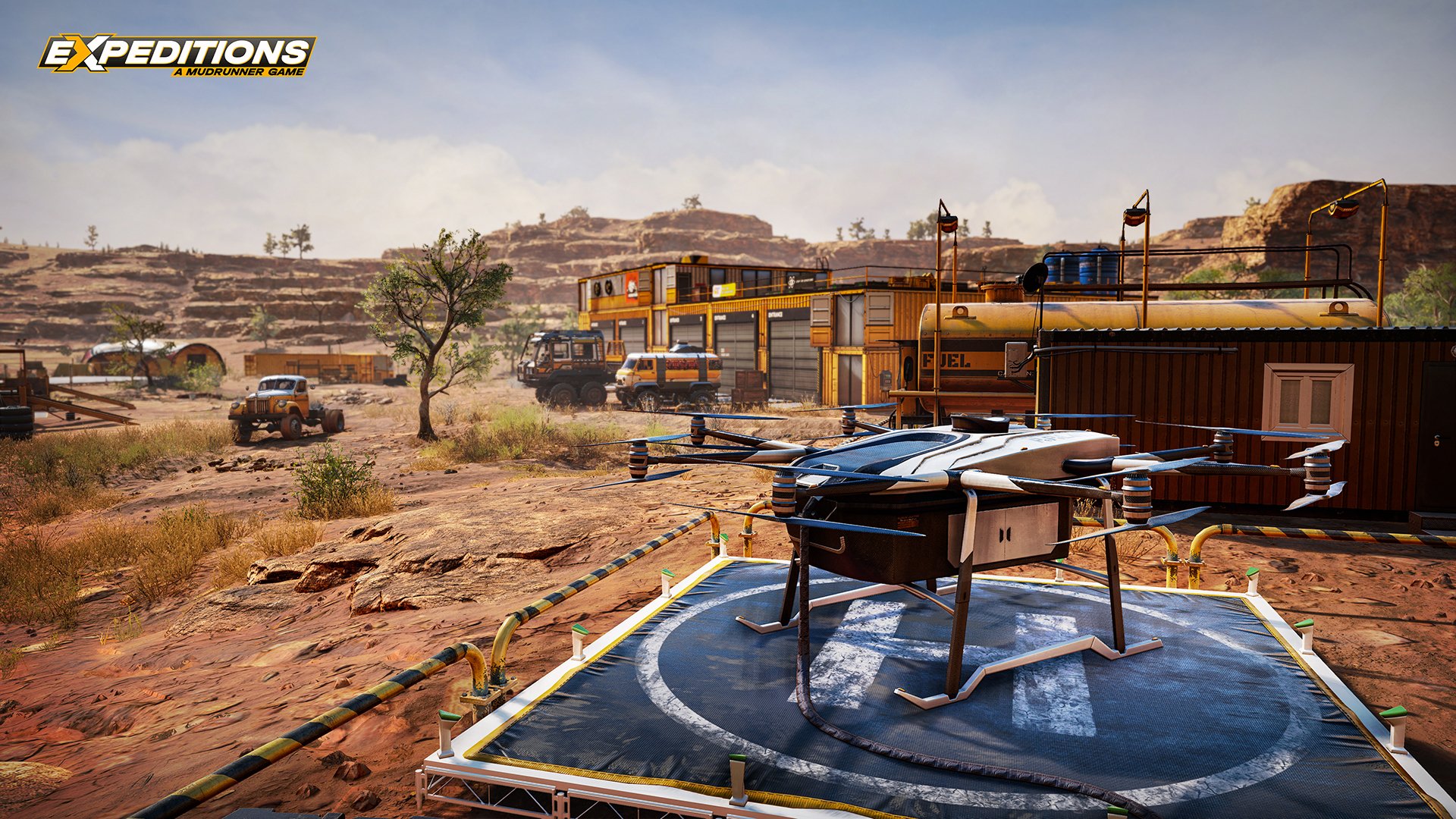 HD Wallpaper of Expeditions: A MudRunner Game featuring rough terrain with a drone, vehicles, and trains in a detailed outpost environment.