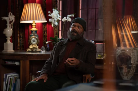 HD wallpaper of a scene from Secret Invasion featuring a character sitting thoughtfully in a warmly lit vintage room with elegant décor.