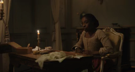 HD wallpaper featuring a thoughtful individual in historical attire sitting at a desk by candlelight, evoking a chevalier-era ambiance.