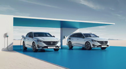 HD desktop wallpaper featuring the Peugeot e-308 in sedan and station wagon models displayed in a sleek, modern setting.