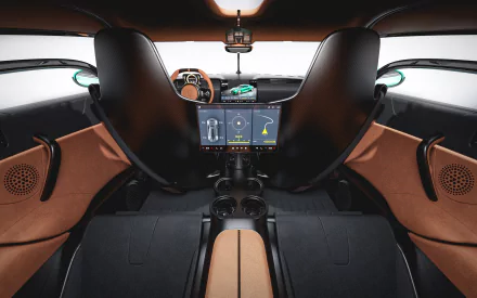 HD wallpaper of the interior of a Koenigsegg Gemera, featuring a sleek dashboard, digital displays, and luxurious leather seating.