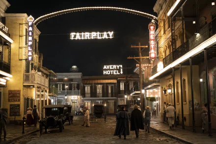HD wallpaper of a vintage street scene from Interview with the Vampire, with lit signage and characters in period costumes.