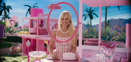 High-definition desktop wallpaper featuring a cheerful woman in a pink Barbie-themed environment from the 2023 Barbie movie.