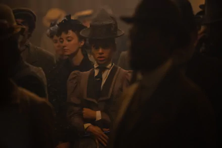 A dramatic scene from Loki Season 2, featuring characters in vintage attire surrounded by a mysterious crowd, set as a high-definition desktop wallpaper.