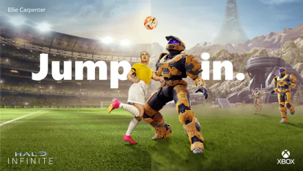 HD desktop wallpaper for Halo Infinite featuring a Spartan from the game playing soccer with a human player on a vibrant field, with the text Jump in.
