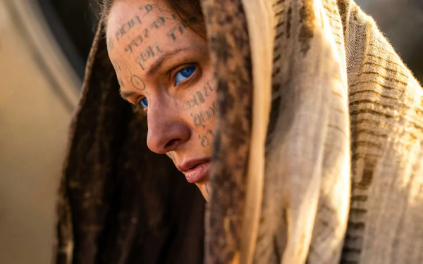 HD desktop wallpaper featuring Rebecca Ferguson in Dune: Part Two with mysterious script on her face.
