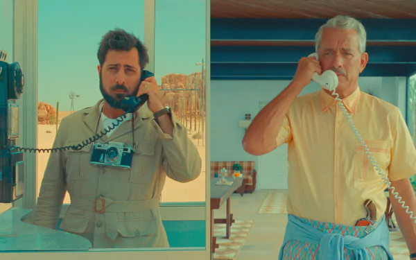 HD desktop wallpaper of Asteroid City featuring two characters on phones in a retro-futuristic setting.