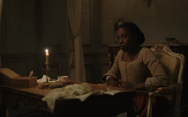 HD wallpaper featuring a thoughtful individual in historical attire sitting at a desk by candlelight, evoking a chevalier-era ambiance.