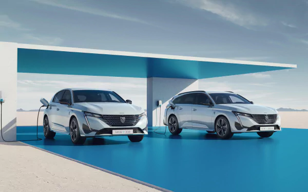 HD desktop wallpaper featuring the Peugeot e-308 in sedan and station wagon models displayed in a sleek, modern setting.