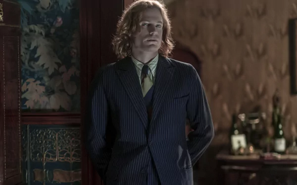 HD wallpaper featuring a scene from Interview with the Vampire, with a character in a pinstripe suit standing in a vintage room.