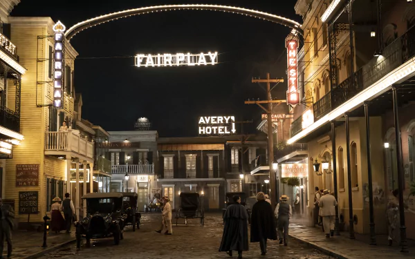 HD wallpaper of a vintage street scene from Interview with the Vampire, with lit signage and characters in period costumes.