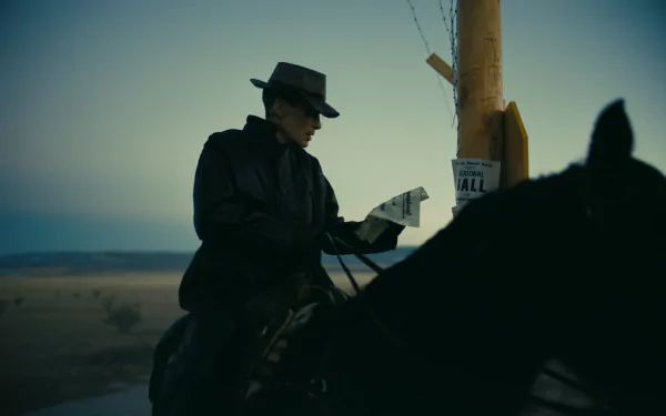HD desktop wallpaper featuring a silhouette of a figure resembling Cillian Murphy as Oppenheimer, on horseback reading near a signpost at dusk, capturing a cinematic atmosphere.