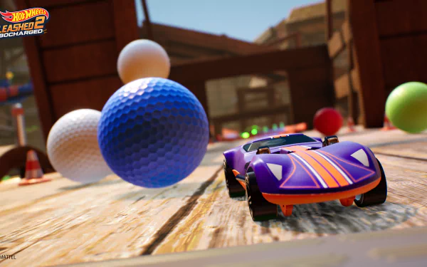 HD desktop wallpaper from Hot Wheels Unleashed 2: Turbocharged featuring a vibrant toy car racing amid oversized colorful balls on a wooden track.