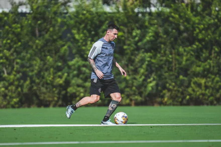 Lionel Messi trains with Inter Miami CF on a lush green field, showcasing his skills and dedication in this high-definition sports desktop wallpaper.