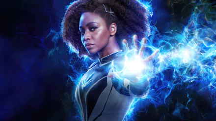 HD movie desktop wallpaper featuring a character from The Marvels, showcasing a powerful pose with energy radiating from her hand.