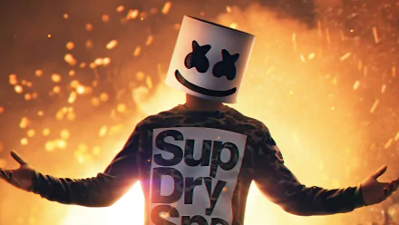 HD desktop wallpaper featuring a figure with the iconic Marshmello headgear, arms open, with a vibrant backdrop of sparkling lights.