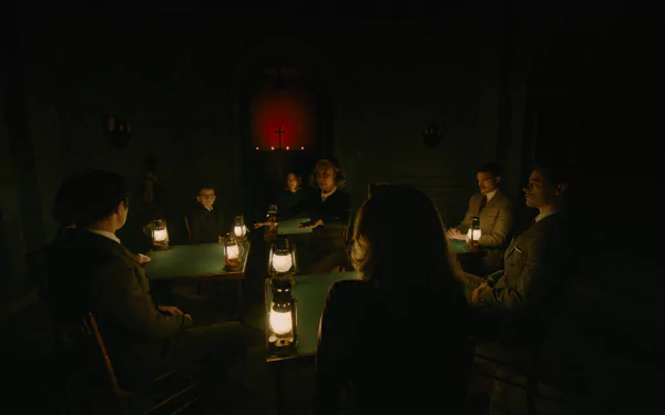 A haunting scene from the movie A Haunting in Venice, featuring a group gathered around a table with lanterns in a dim room, creating an eerie atmosphere for this HD desktop wallpaper.