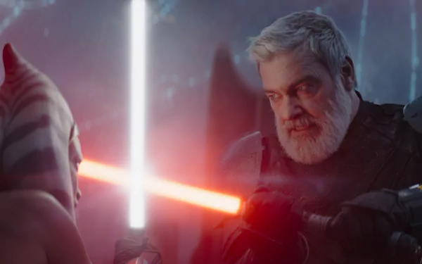 HD wallpaper featuring an intense moment between Ahsoka Tano with lightsaber and Baylan Skoll with blurred background, capturing a dynamic scene from their storyline.