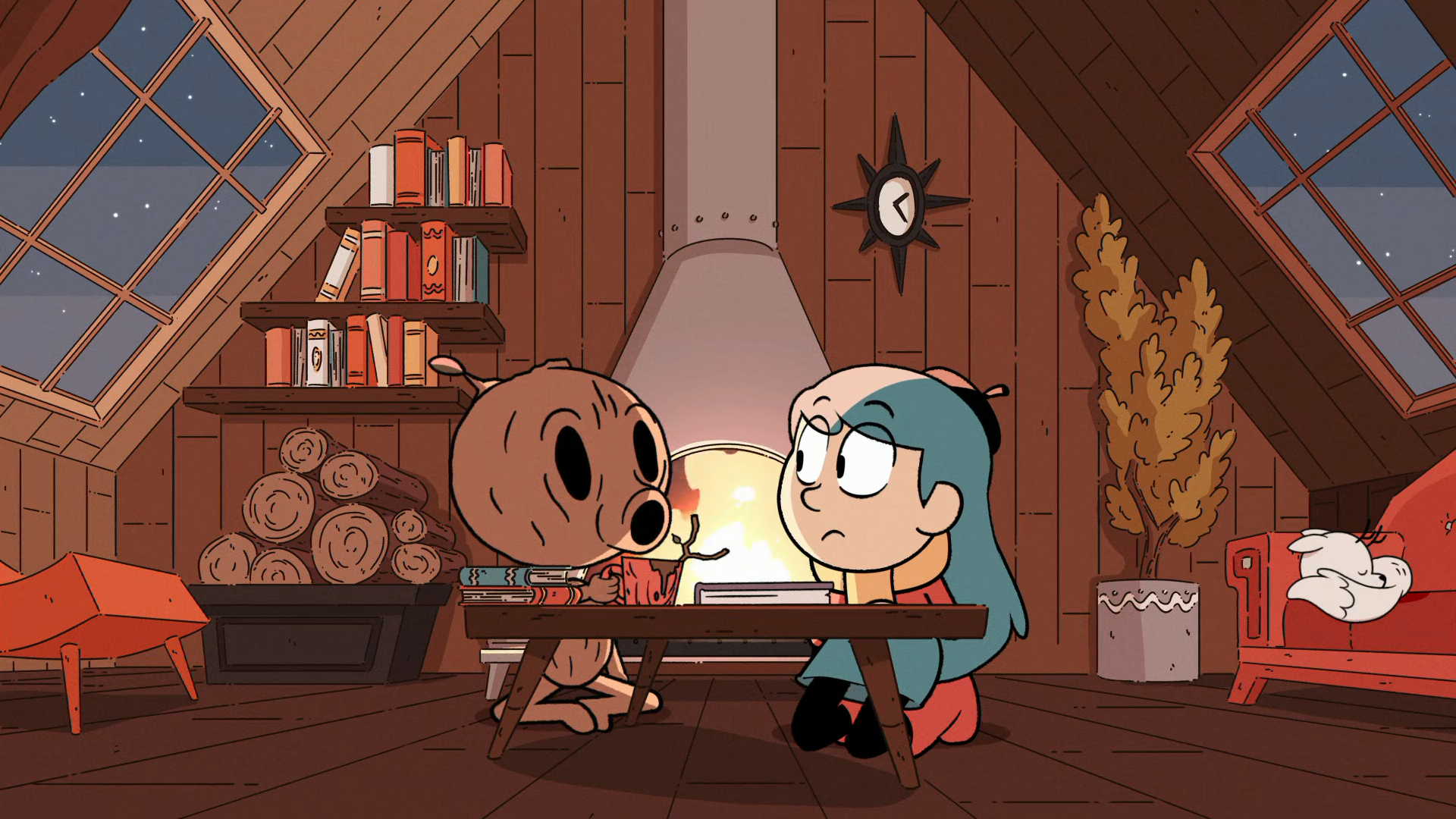A cozy scene from the TV show Hilda, featuring Hilda and a friendly creature sitting at a table in a warm, wooden cabin with a fireplace and bookshelves in the background.