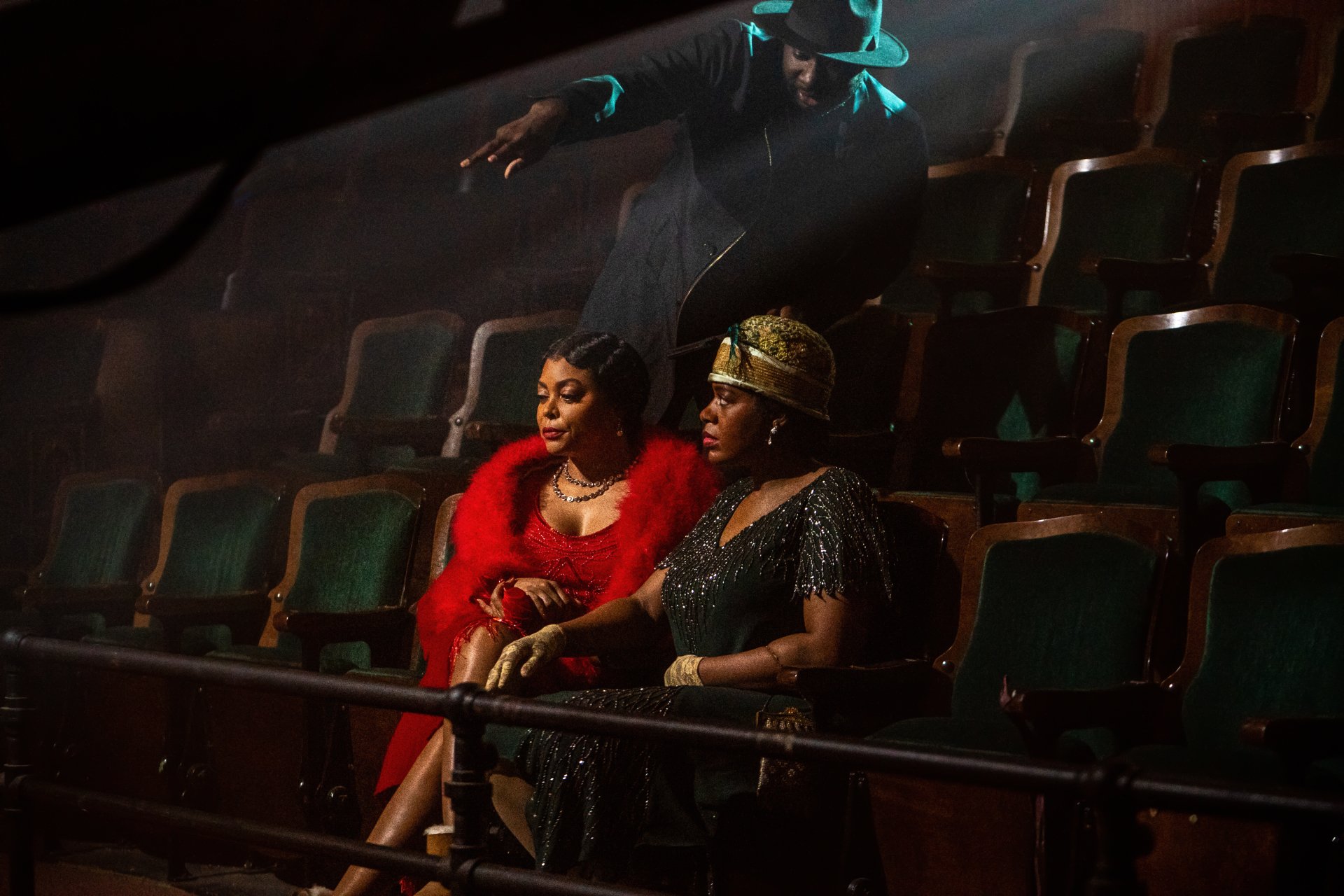 Two characters from the 2023 movie The Color Purple sitting contemplatively in a theater, featured in a high-definition desktop wallpaper.