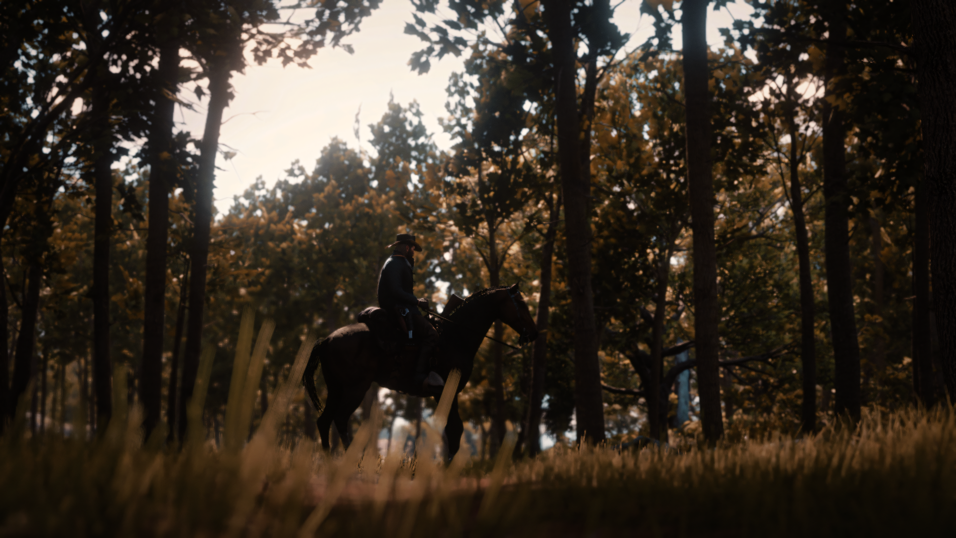 Arthur Morgan rides through a sunlit forest landscape in Red Dead Redemption 2, showcased in 8K Ultra HD as a PC desktop wallpaper by Rockstar Games.