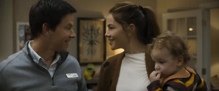 HD wallpaper of a smiling couple close together with a young child, evoking 'The Family Plan' theme for desktop backgrounds.