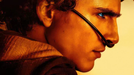 A striking HD wallpaper featuring Timothée Chalamet as Paul Atreides in *Dune: Part Two*, showcasing his intense expression and iconic desert gear against a dramatic backdrop.
