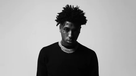 Monochrome HD wallpaper featuring a young rapper in a black sweater and chain, embodying the music theme.