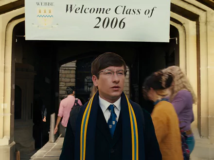HD desktop wallpaper from the 2023 movie Saltburn featuring a man in a blue blazer and yellow scarf standing in an archway with the date 2006 above.