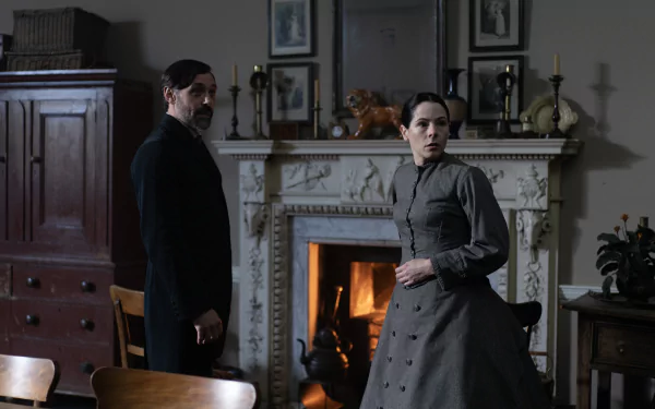 HD wallpaper featuring a scene from Belgravia: The Next Chapter with two characters in a dimly lit Victorian room with a fireplace.