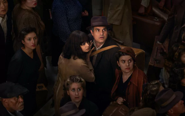 HD wallpaper featuring a tense scene from the TV Show All the Light We Cannot See with crowd of period-dressed characters.