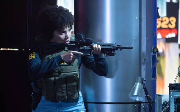 A scene from *The Beekeeper*, featuring a character in tactical gear, aiming a rifle in a dynamic setting. This captivating image serves as an HD wallpaper for fans of the film.